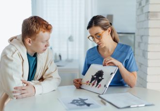 Teenager taking Rorschach test during psychological therapy with adolescent psychologist